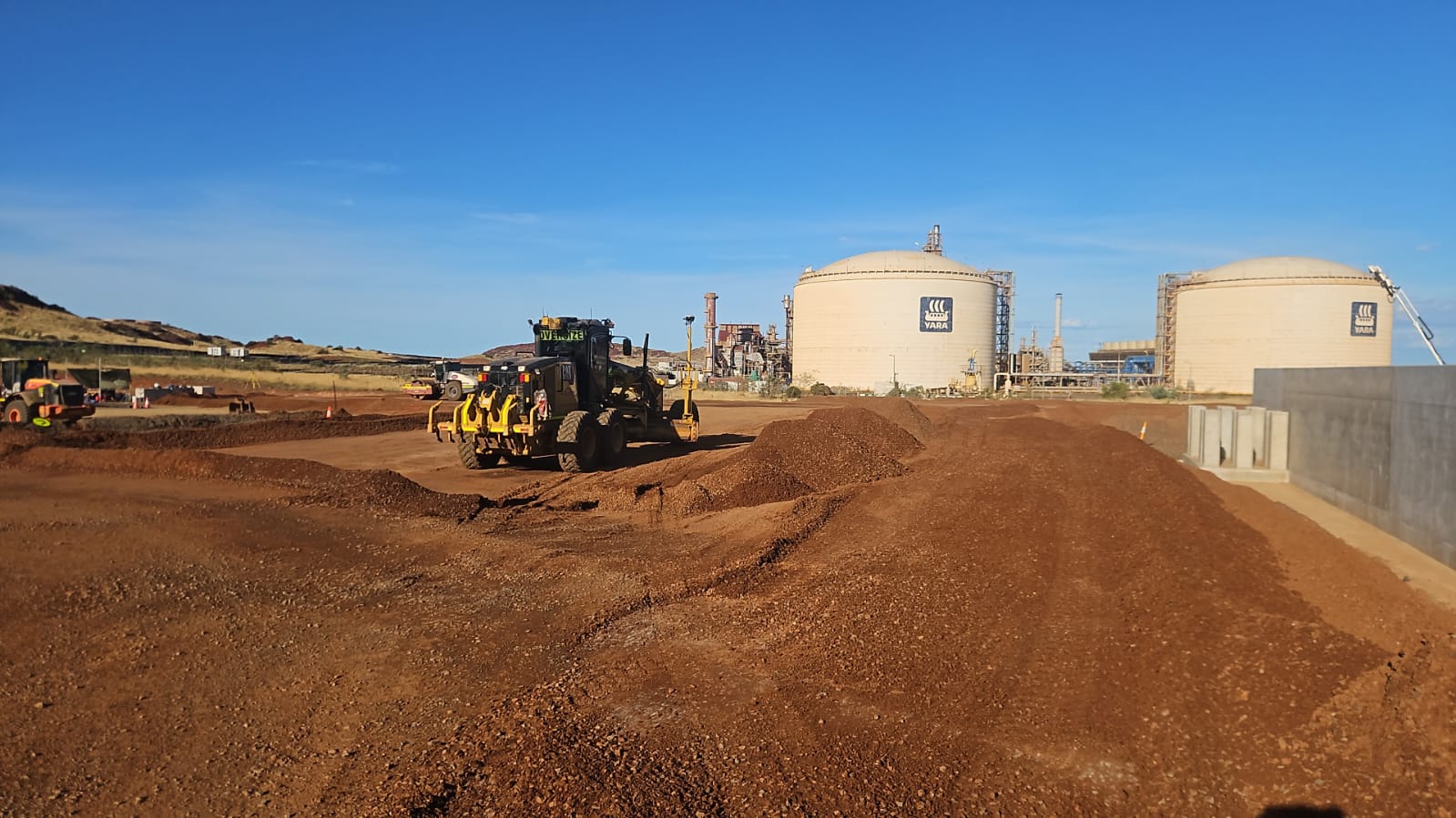 Grader performing final trim
